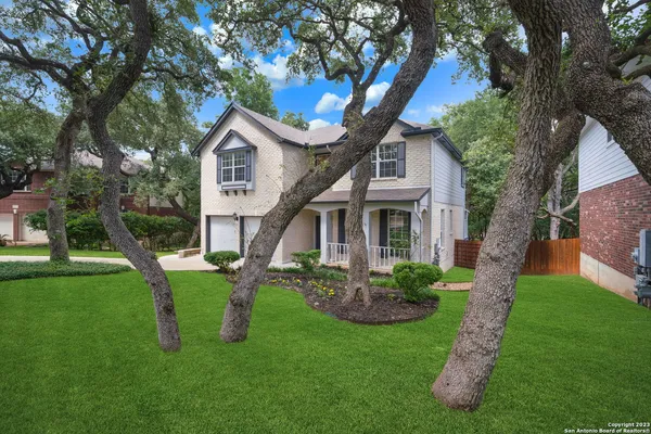 a front view of house with a garden