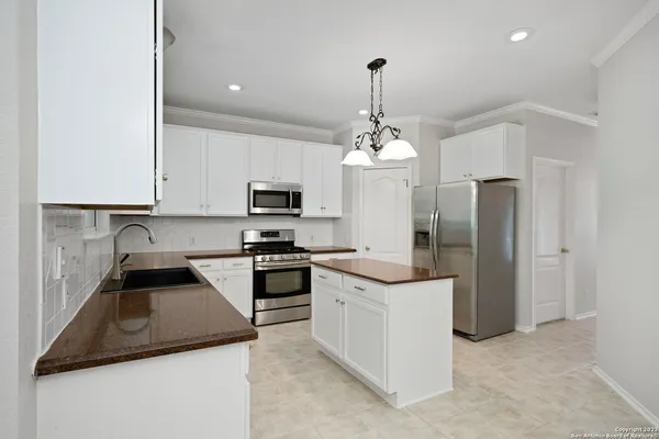 a large kitchen with cabinets and stainless steel appliances