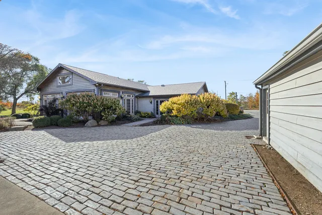 a front view of a house with a yard and a garage