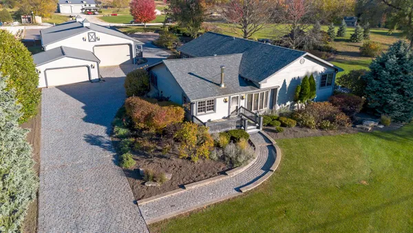 an aerial view of house with swimming pool