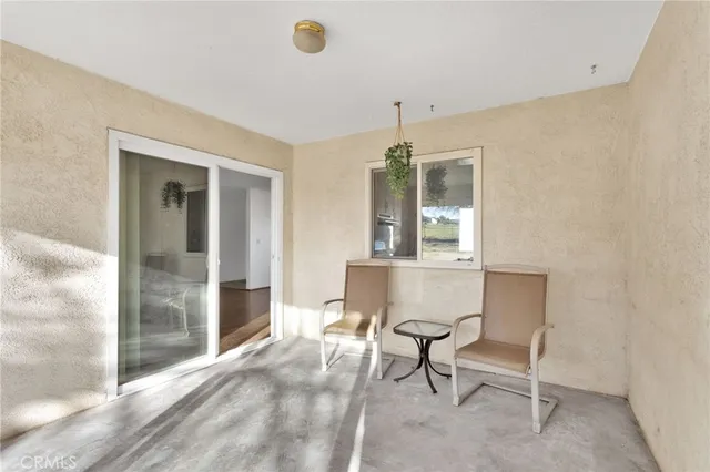 a view of a livingroom with furniture and a window