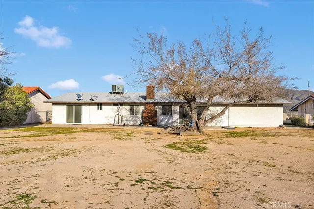 a view of a house with snow on the road