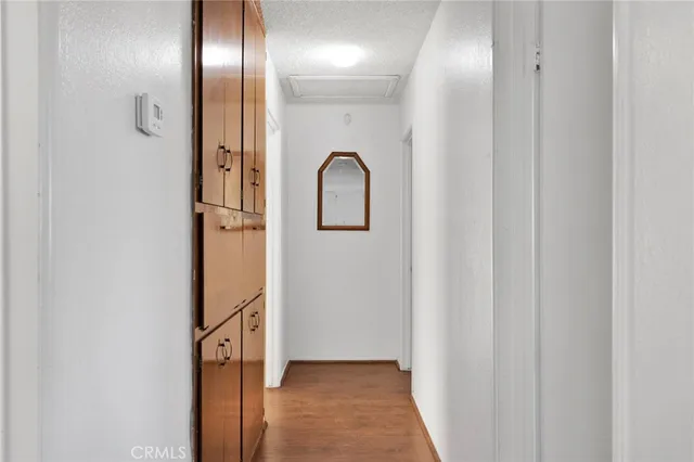 a view of a hallway with wooden floor