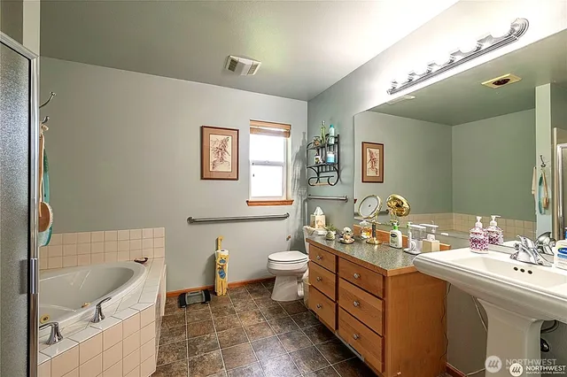 a bathroom with a tub and shower