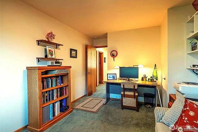 a living room with furniture a window and a flat screen tv