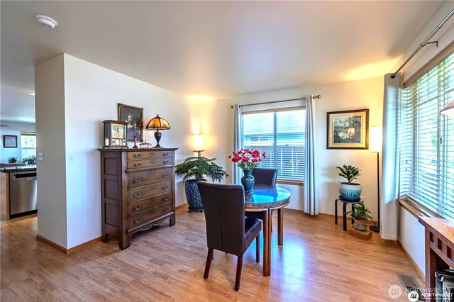 a view of a dining room with furniture and a potted plant