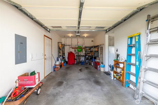 a view of a patio with table and chairs under an umbrella