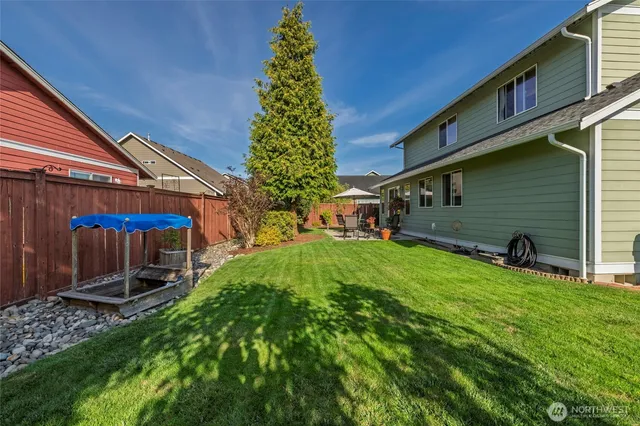a view of a backyard with plants and a patio