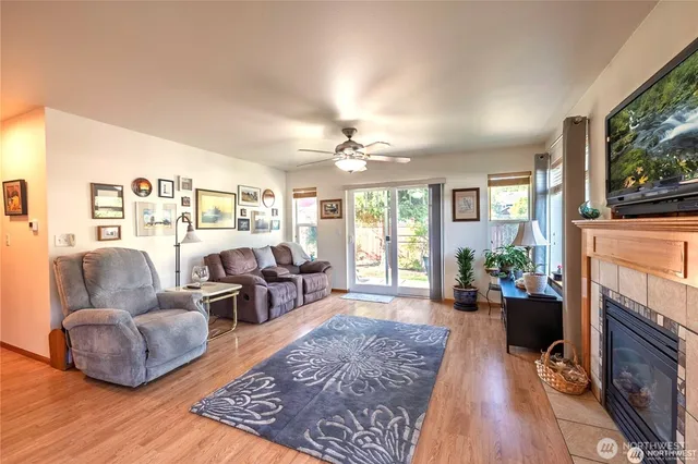 a living room with furniture fireplace and flat screen tv