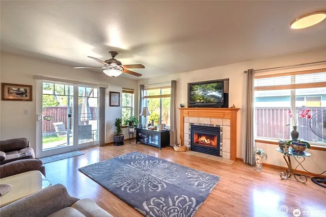 a living room with furniture fireplace and window