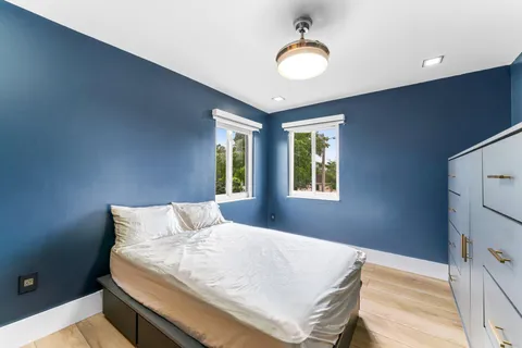 a bedroom with a bed and window
