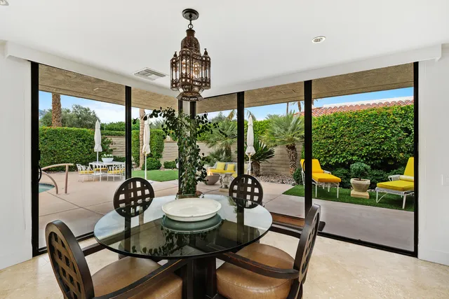a swimming pool with outdoor seating and yard