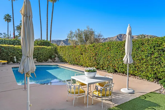 a bedroom with furniture and large windows