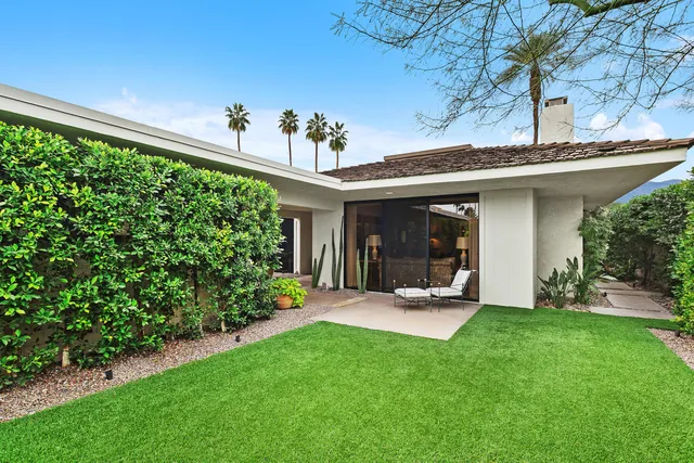 a view of a house with porch and garden