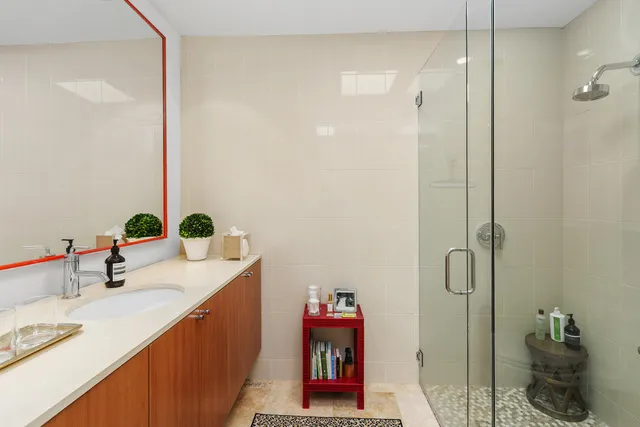a bathroom with a sink mirror vanity and toilet