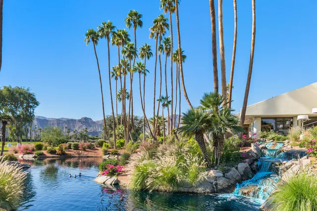 a dining hall with stainless steel appliances granite countertop a dining table and chairs