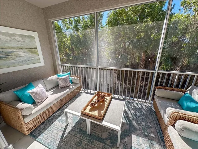 a outdoor living room with furniture and a window