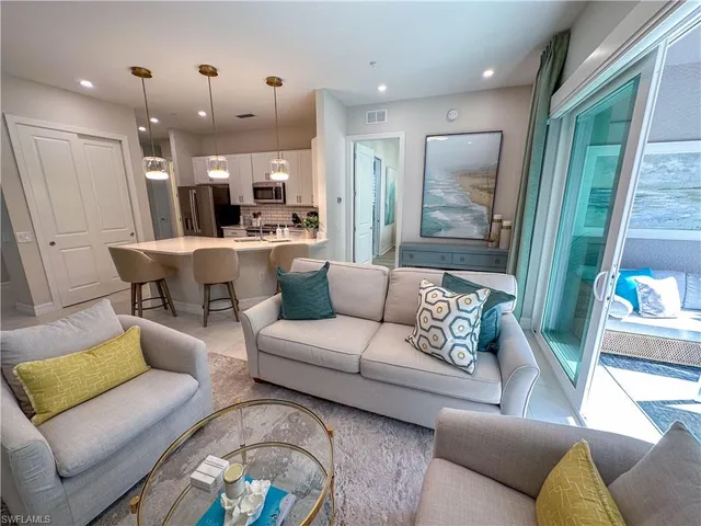 a living room with furniture and a large mirror