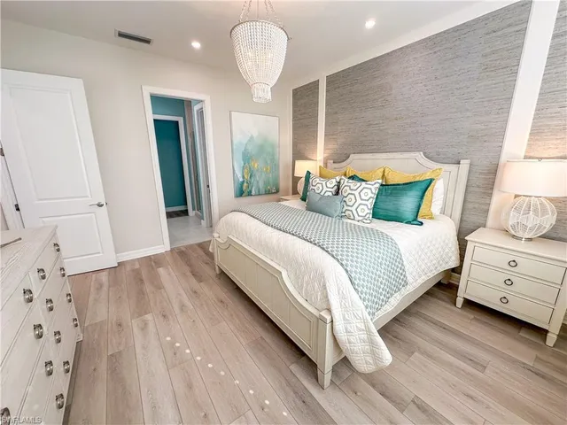 a large white bed in a white room