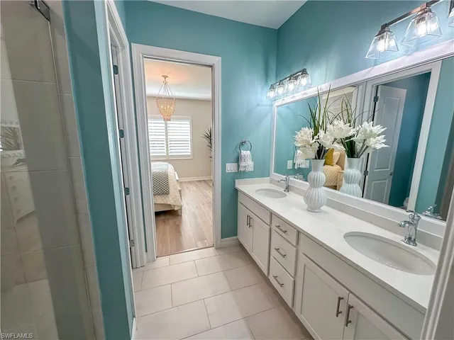a spacious bathroom with a double vanity sink and a mirror