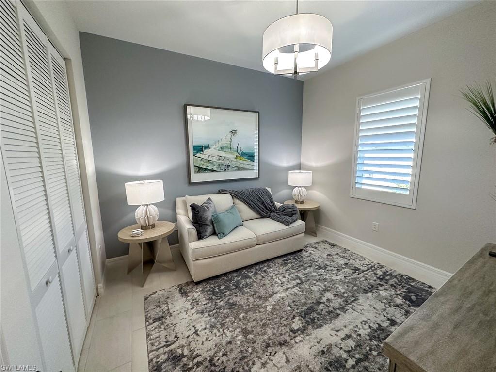 232 Indies Drive East, Unit 201 Naples, FL 34114 - Photo 37 of 49 a living room with furniture and a window