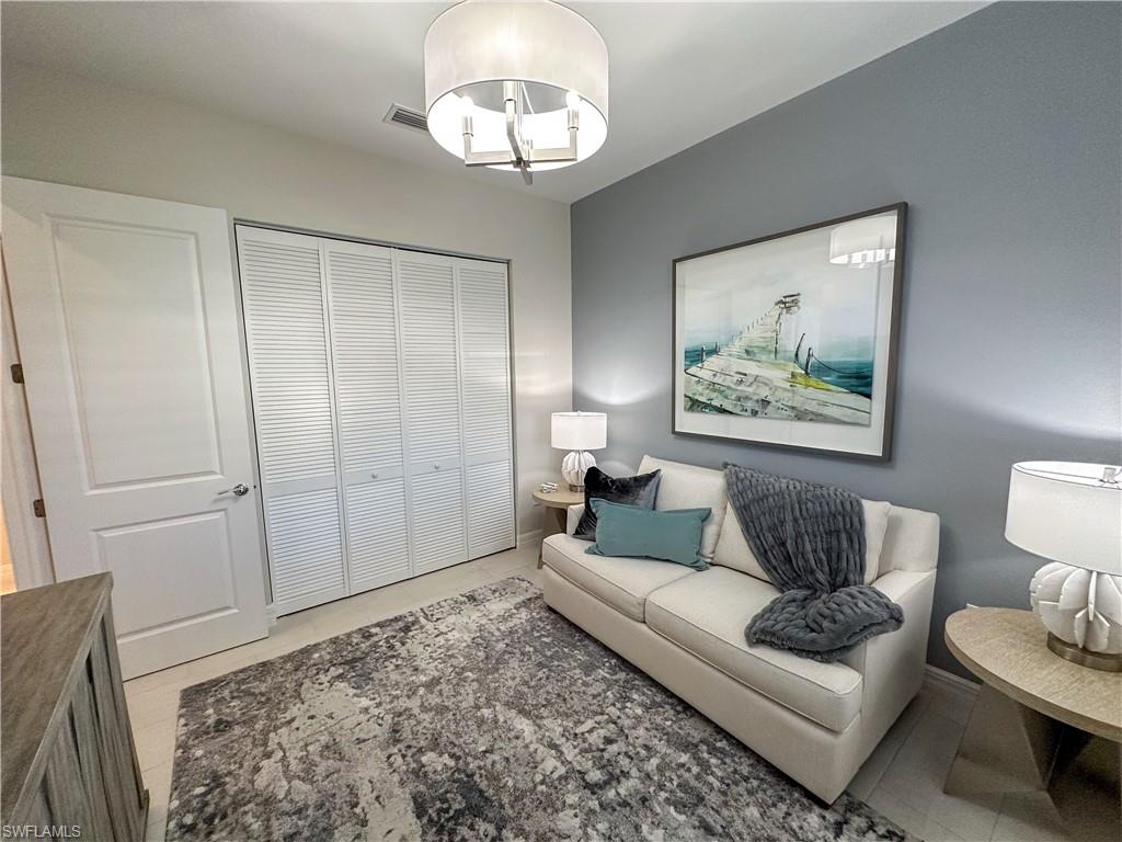 232 Indies Drive East, Unit 201 Naples, FL 34114 - Photo 38 of 49 a living room with furniture and a wooden floor