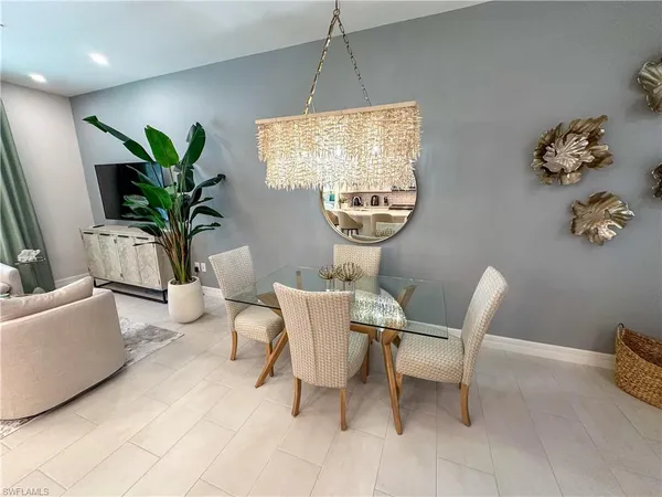 a living room with furniture a window and a potted plant