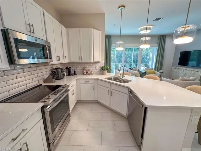 a kitchen with a sink stove and microwave