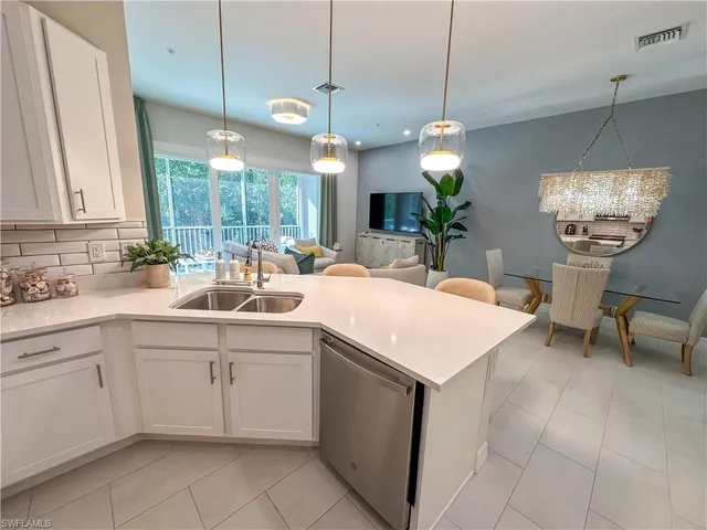 a kitchen with a sink and chandelier