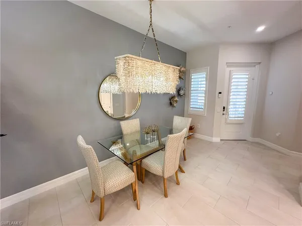 a dining room with furniture and a mirror