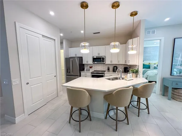 a large kitchen with a table and chairs