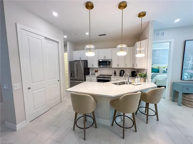 a large kitchen with a table and chairs