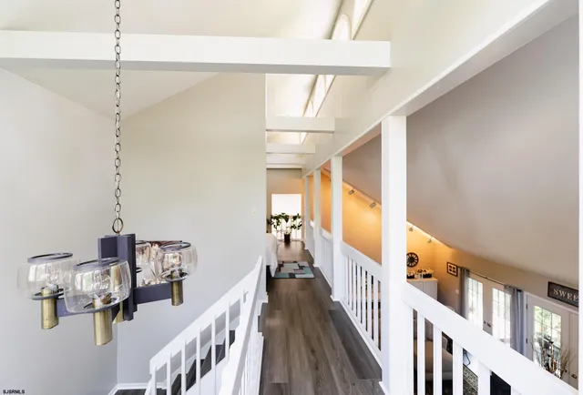 a view of staircase with railing and white walls