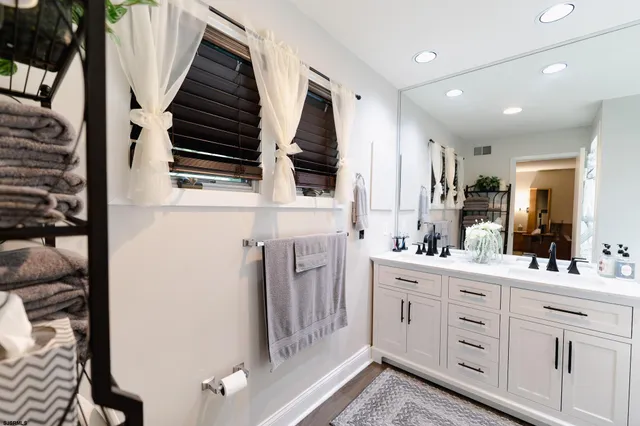 a bathroom with a double vanity sink and mirror