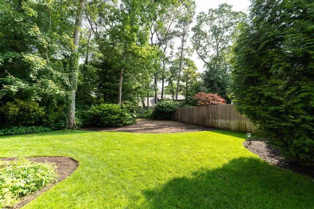 a swimming pool with trees in the background