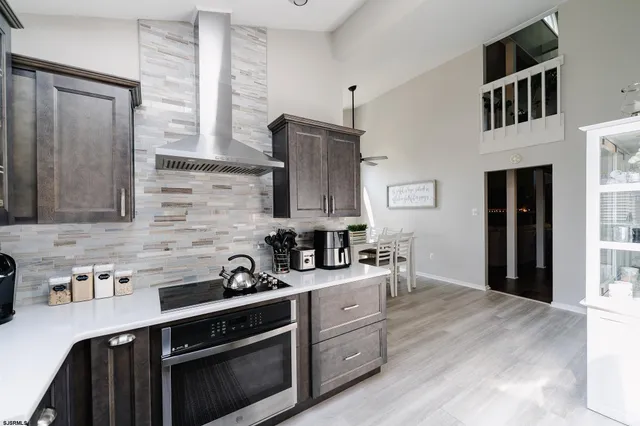 a kitchen with stainless steel appliances a sink stove and cabinets