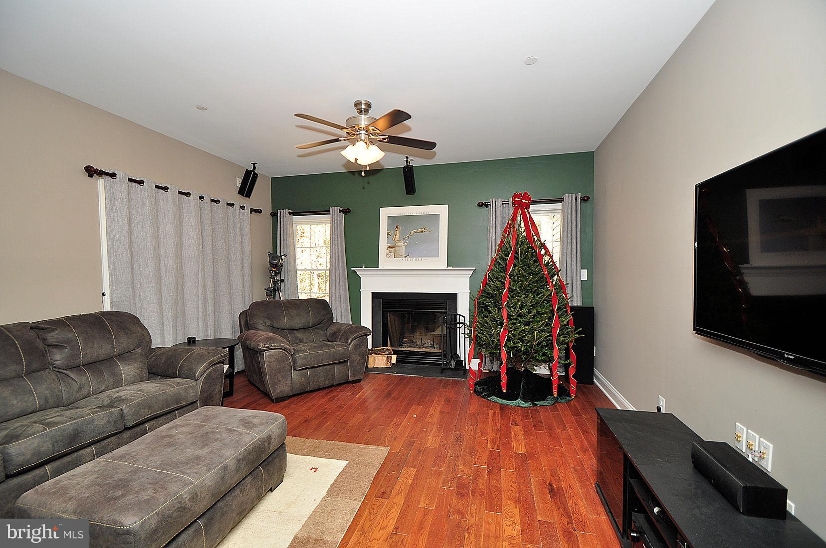 7720 Paradise Beach Road Pasadena, MD 21122 - Photo 12 of 23 Cozy family room with fireplace