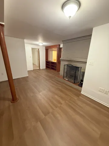 an empty room with fireplace and windows