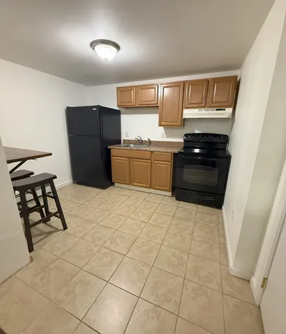 a bathroom with a sink mirror and shower