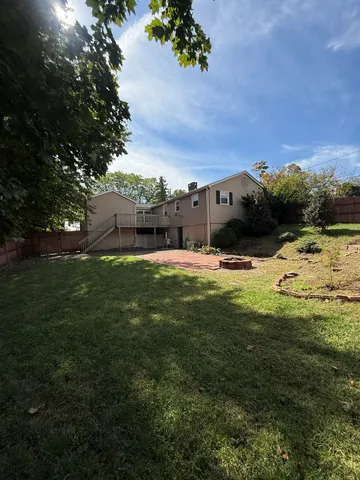 a view of a big yard with table and chairs