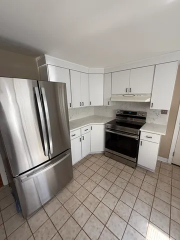 a kitchen with stainless steel appliances a refrigerator sink and cabinets
