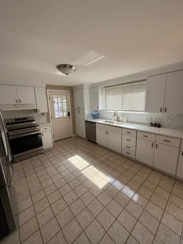 a kitchen with stainless steel appliances granite countertop a sink and cabinets