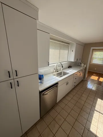 a kitchen with a sink and a refrigerator