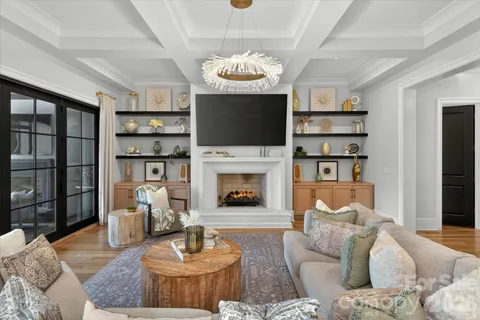 a living room with furniture a fireplace and a flat screen tv