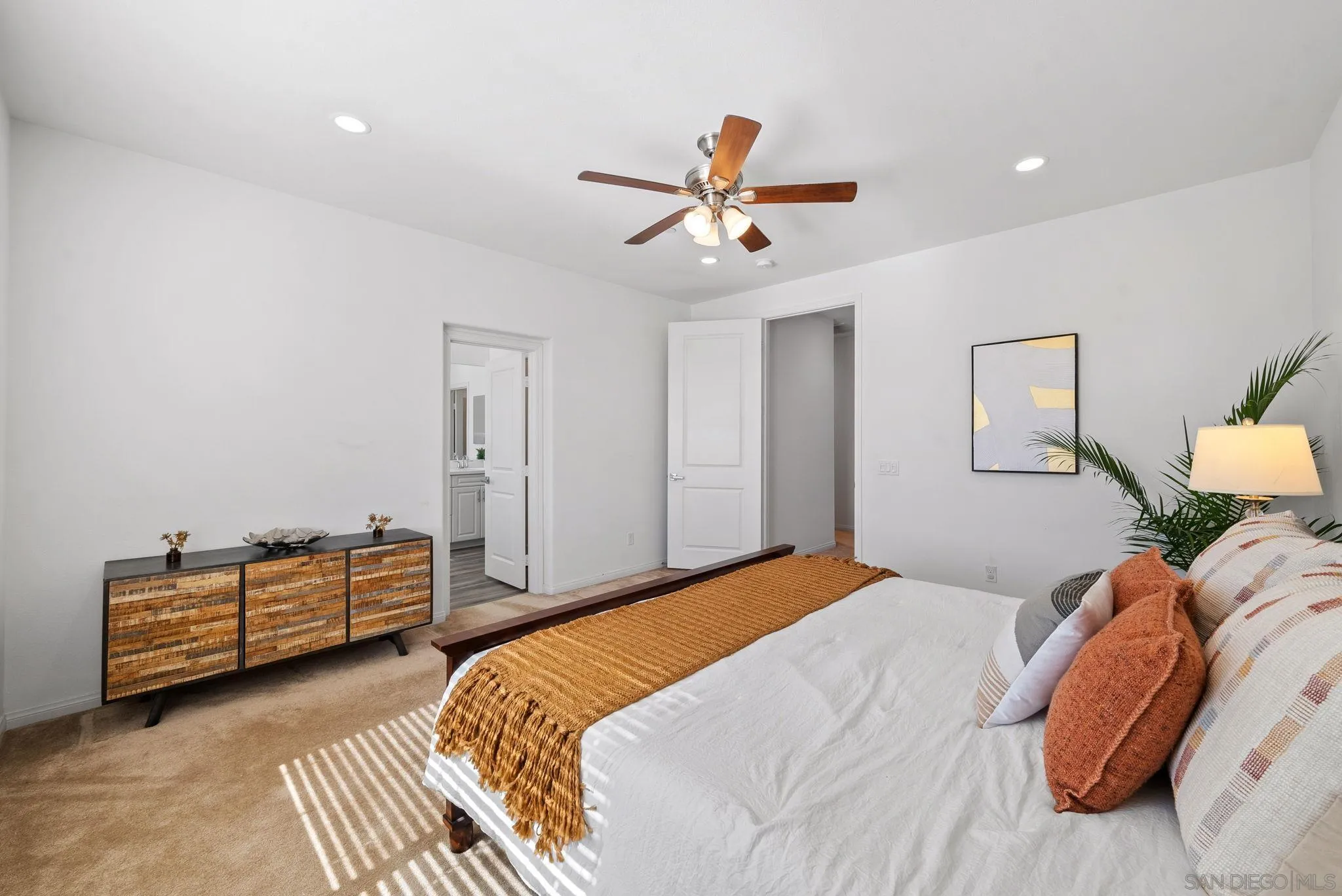 8749 Scrub Oak Street Santee, CA 92071 - Photo 12 of 43 a bedroom with a bed and a chandelier