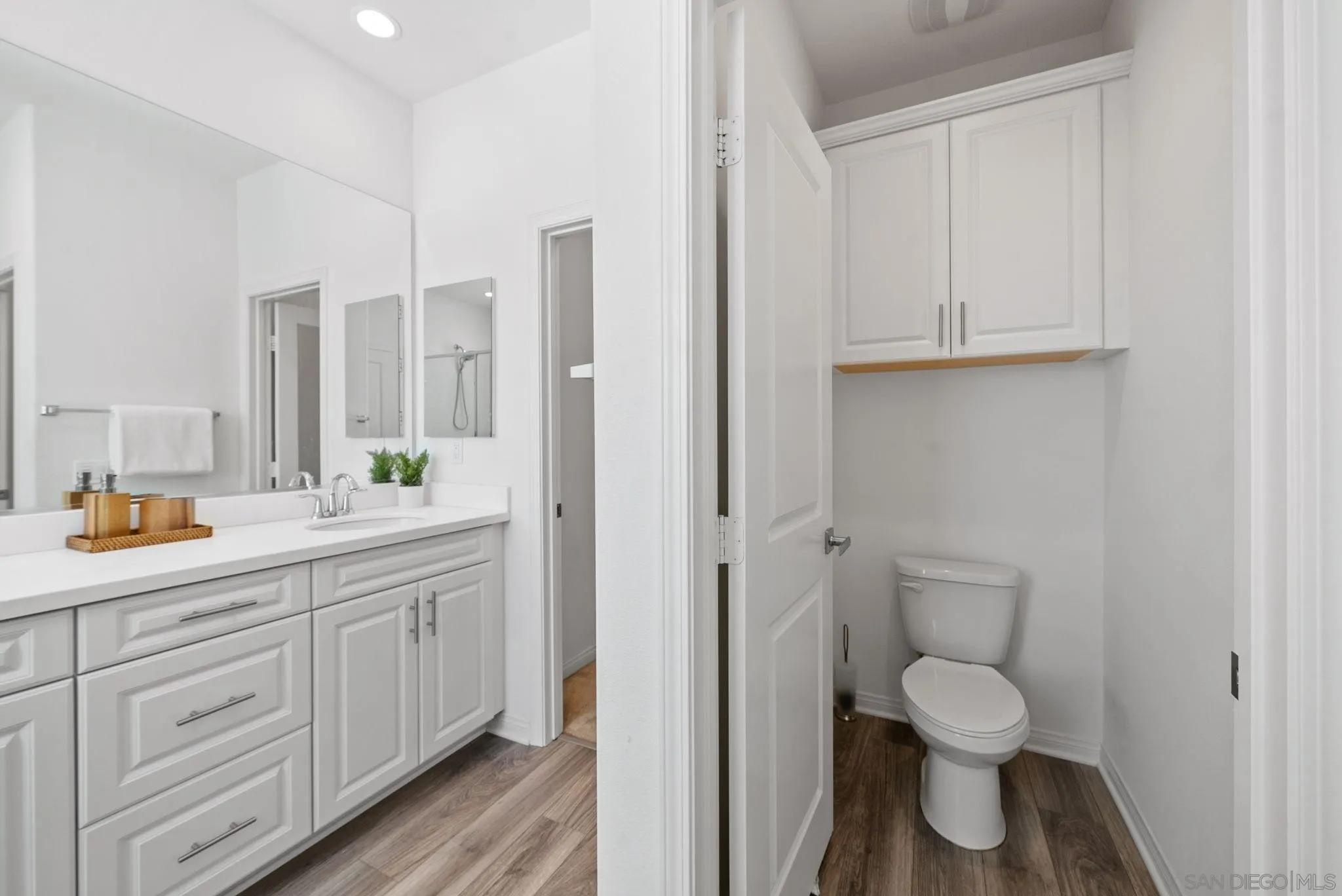 8749 Scrub Oak Street Santee, CA 92071 - Photo 15 of 43 a bathroom with a toilet sink and mirror