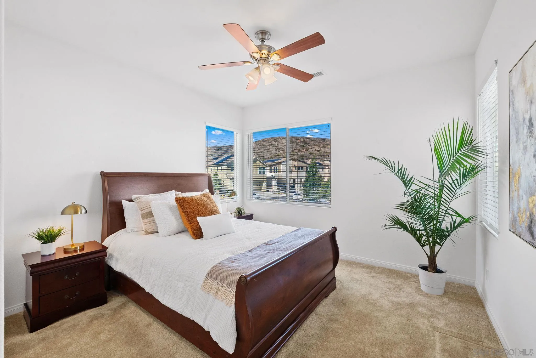 8749 Scrub Oak Street Santee, CA 92071 - Photo 17 of 43 a bedroom with a large bed plant and a potted plant