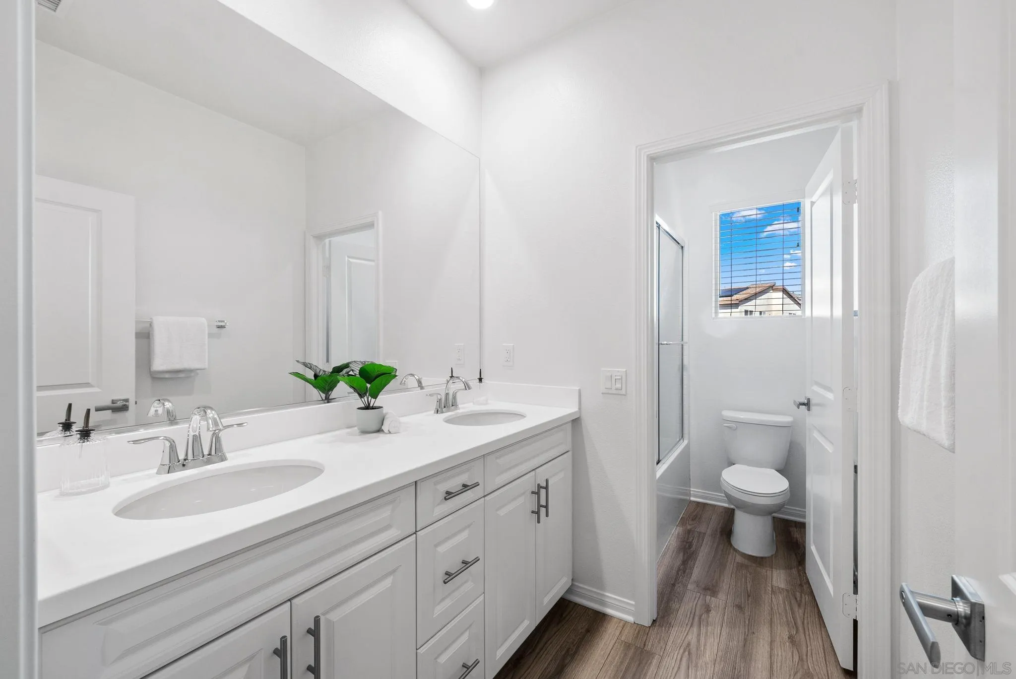 8749 Scrub Oak Street Santee, CA 92071 - Photo 19 of 43 a bathroom with a sink a toilet and a large mirror