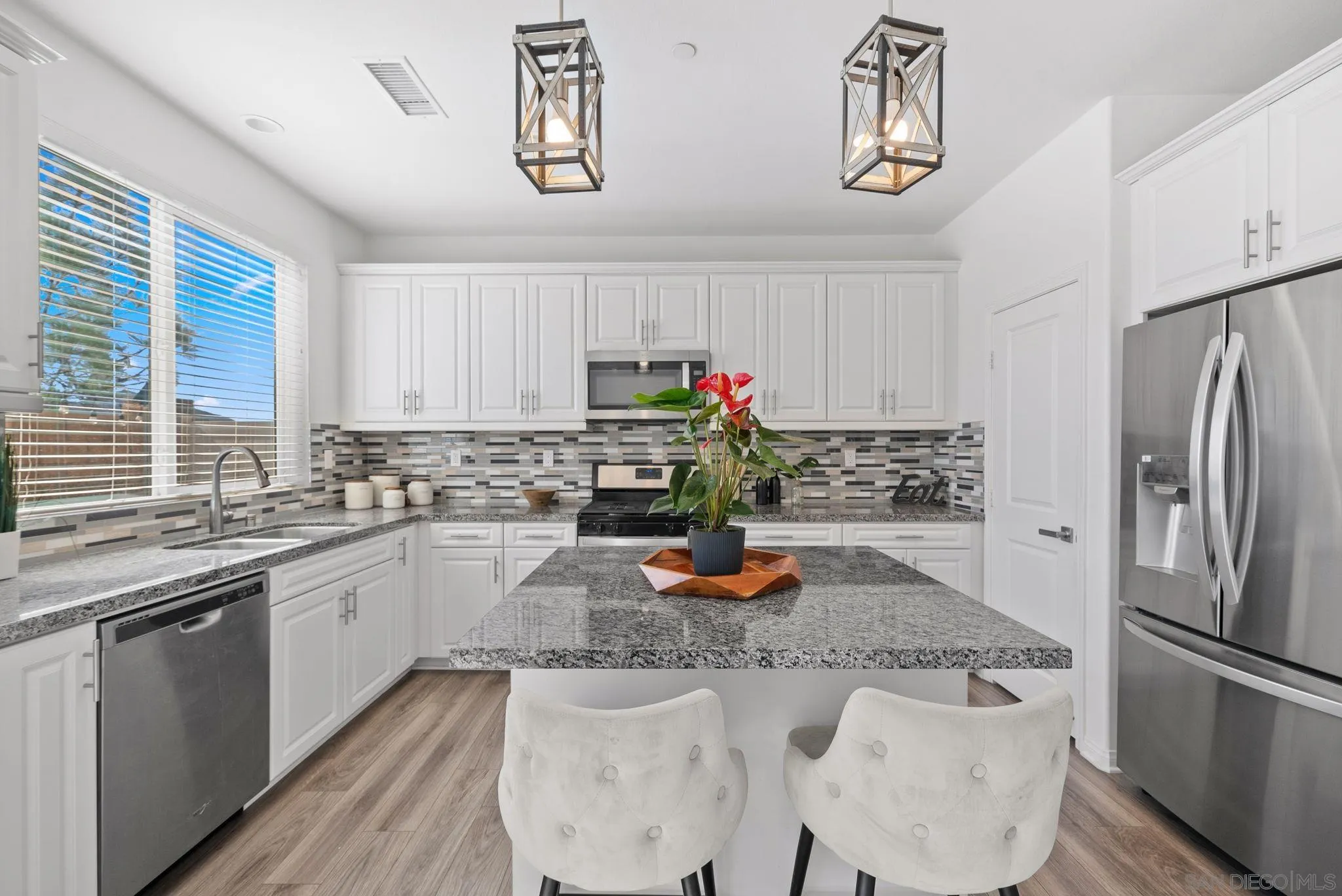 8749 Scrub Oak Street Santee, CA 92071 - Photo 2 of 43 a kitchen with a refrigerator and a sink