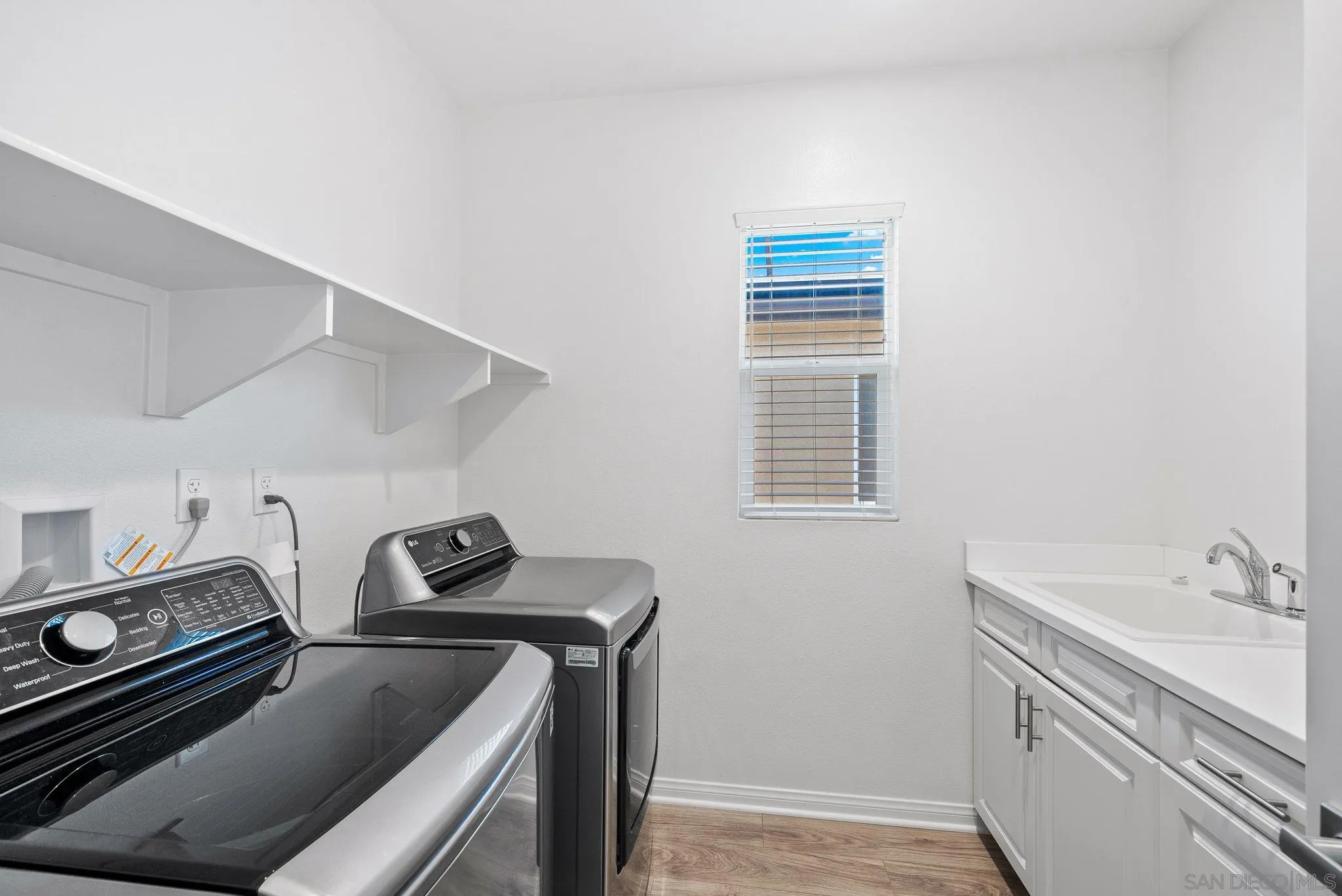 8749 Scrub Oak Street Santee, CA 92071 - Photo 23 of 43 a utility room with dryer and washer